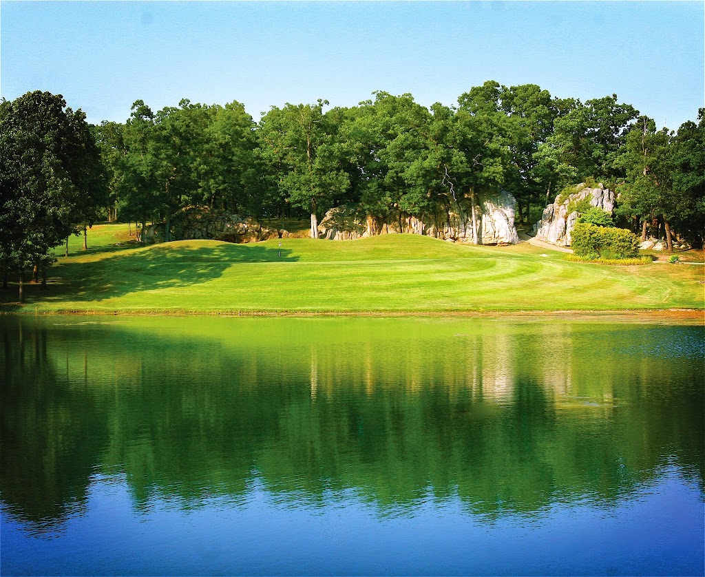 Panoramic view of a lush green golf course at Indian Rock Golf Club. Smooth