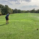 green grass with the flag in the hole.