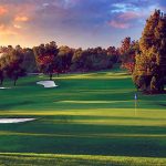 Panoramic view of a lush green golf course at Industry Hills Golf Club at Pacific Palms Resort. Smooth