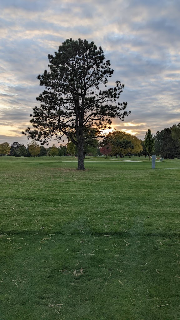 Panoramic view of a lush green golf course at Irv Warren Memorial Golf Course. Smooth