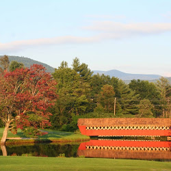 Panoramic view of a lush green golf course at Jack O'Lantern Resort. Smooth