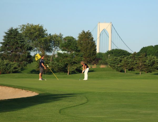 Panoramic view of a lush green golf course at Jamestown Golf Course. Smooth