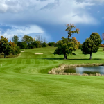 Panoramic view of a lush green golf course at Jefferson Golf Course. Smooth