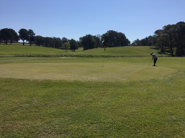 Panoramic view of a lush green golf course at Jerry Brooks Golf Course. Smooth