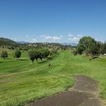 Panoramic view of a lush green golf course at John Day Golf Club. Smooth