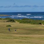 Panoramic view of a lush green golf course at Kahuku Golf Course. Smooth