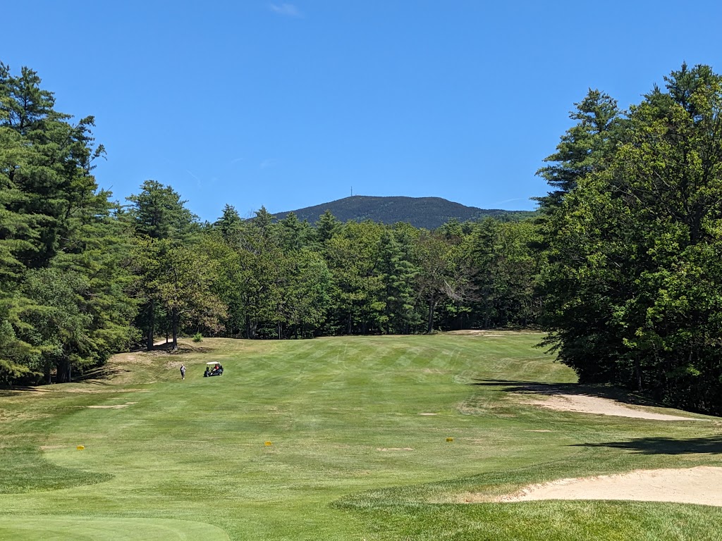 Panoramic view of a lush green golf course at Kearsarge Valley Golf Course. Smooth