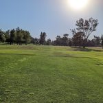 Panoramic view of a lush green golf course at Kern River Golf Course. Smooth