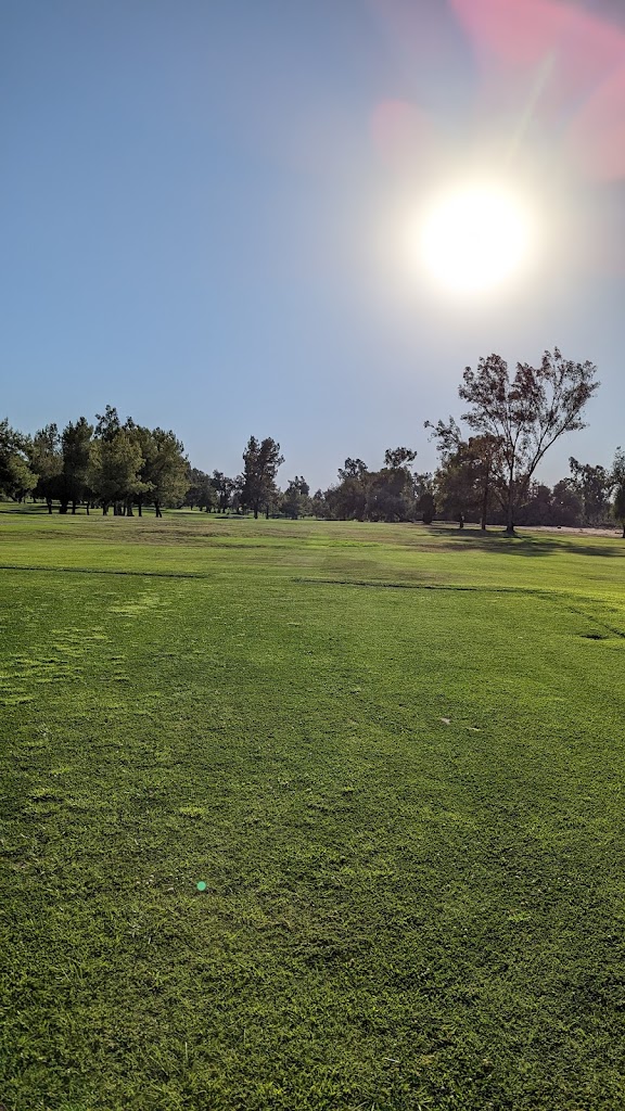 Panoramic view of a lush green golf course at Kern River Golf Course. Smooth