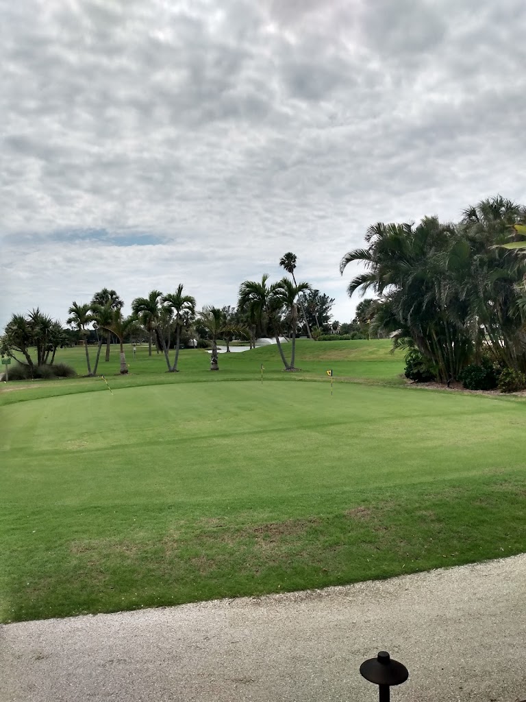 Panoramic view of a lush green golf course at Key Royale Club Inc.. Smooth