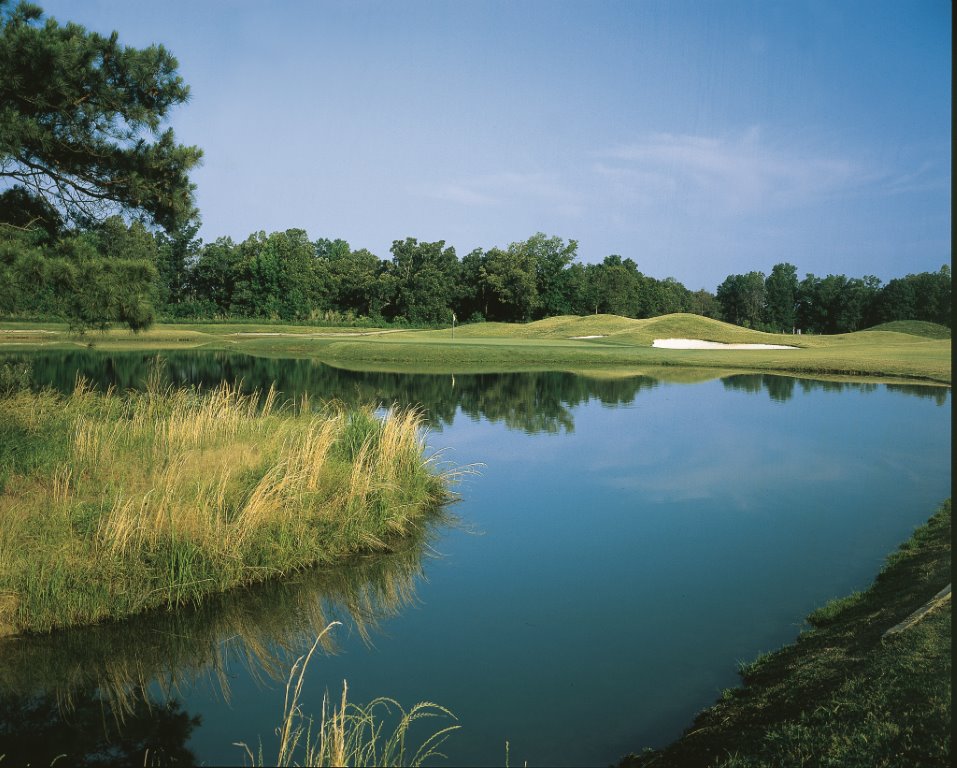 Panoramic view of a lush green golf course at Kirkwood National Golf Club & Cottages. Smooth