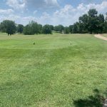 Panoramic view of a lush green golf course at L. A. Nickell Golf Course. Smooth