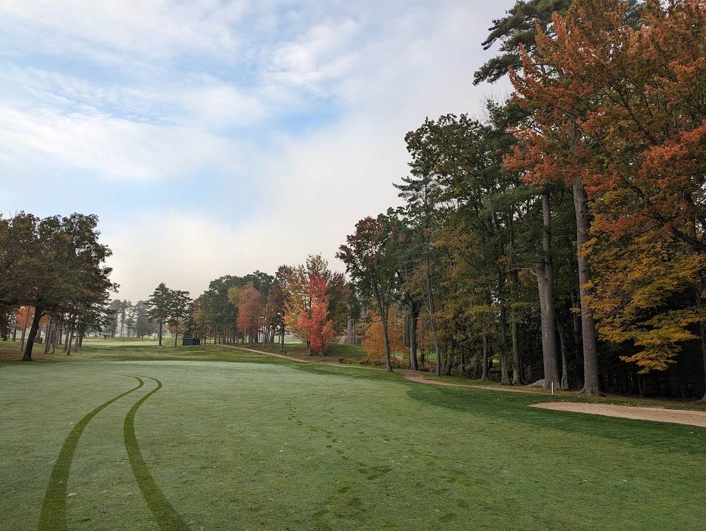 Panoramic view of a lush green golf course at Laconia Country Club. Smooth