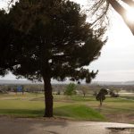 Panoramic view of a lush green golf course at Lake Carlsbad Golf Course. Smooth