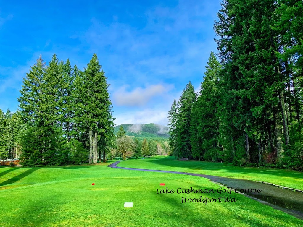 Panoramic view of a lush green golf course at Lake Cushman Golf Course. Smooth