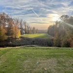 Panoramic view of a lush green golf course at Lake Presidential Golf Club. Smooth