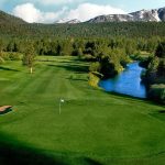 Panoramic view of a lush green golf course at Lake Tahoe Golf Course. Smooth