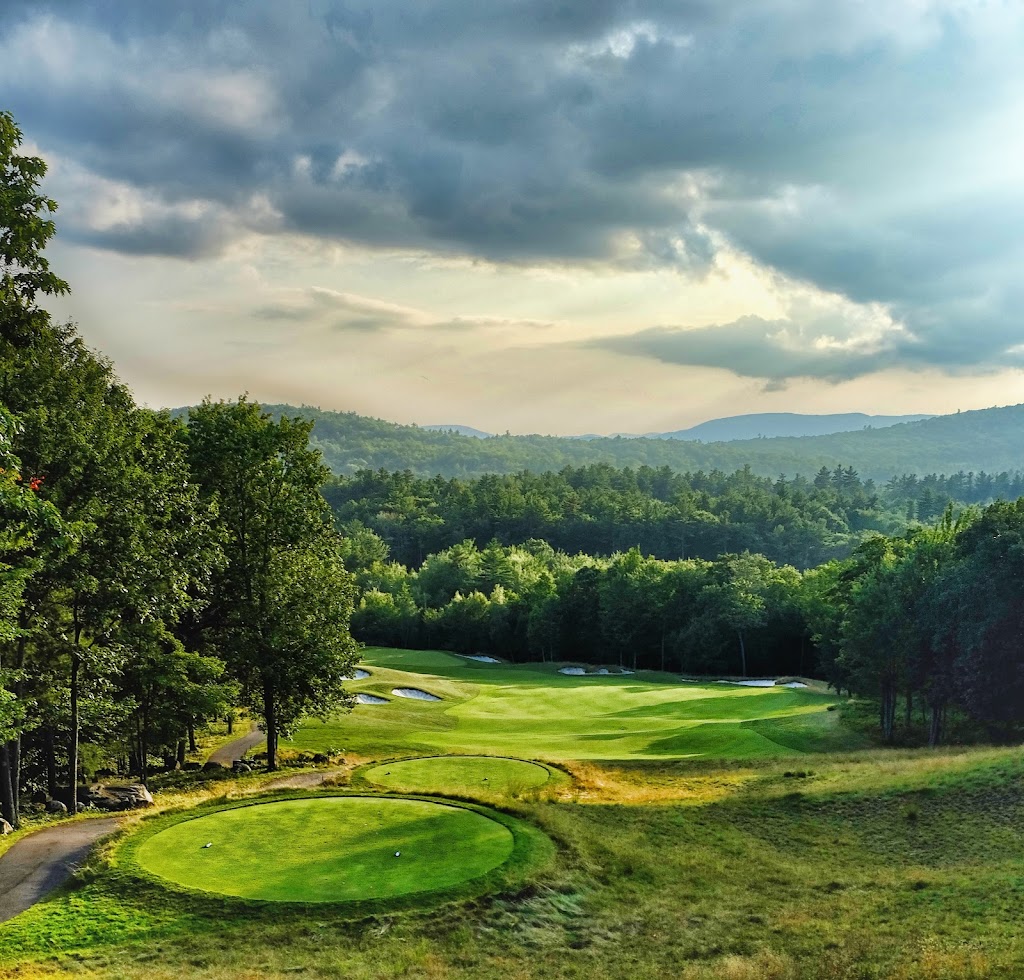 Panoramic view of a lush green golf course at Lake Winnipesaukee Golf Club. Smooth