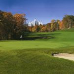 Panoramic view of a lush green golf course at Lake of Isles. Smooth