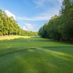 Panoramic view of a lush green golf course at Lake of The Woods Golf Club. Smooth