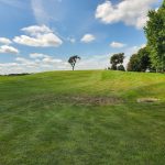 Panoramic view of a lush green golf course at Lakeside Municipal Golf Course. Smooth