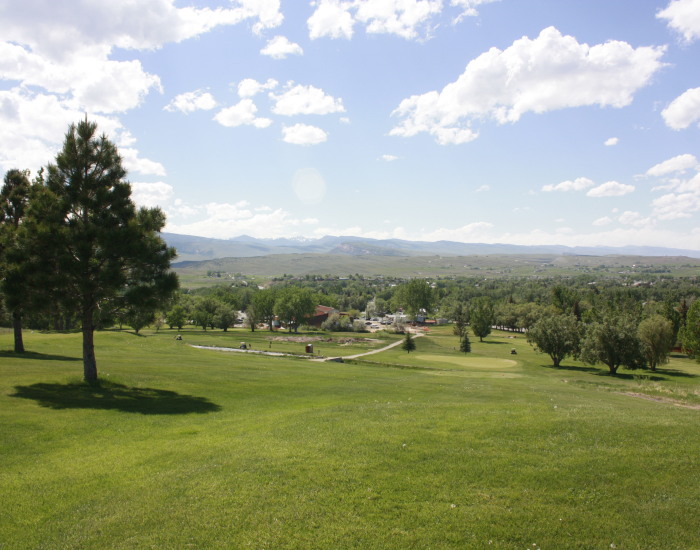 Panoramic view of a lush green golf course at Lander Golf Course & Duncle's Bar & Grill. Smooth