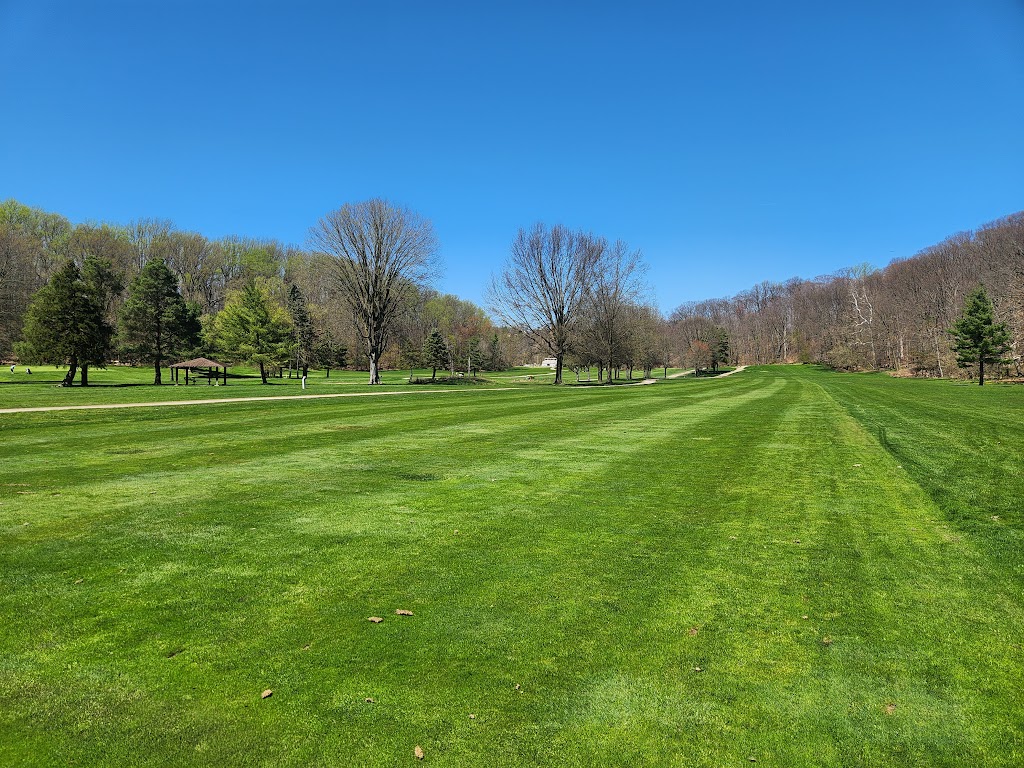 Panoramic view of a lush green golf course at Little Met Golf Course. Smooth