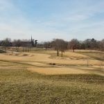 Panoramic view of a lush green golf course at Log Cabin Club. Smooth