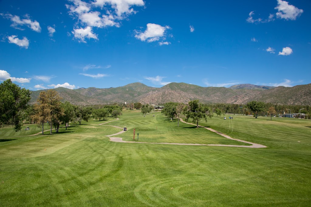 Panoramic view of a lush green golf course at Los Alamos County Golf Course. Smooth