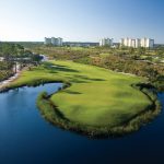 Panoramic view of a lush green golf course at Lost Key Golf Club. Smooth