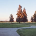 Panoramic view of a lush green golf course at Madera Municipal Golf Course. Smooth