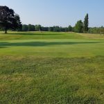 Panoramic view of a lush green golf course at Maine Golf Center Freeport. Smooth