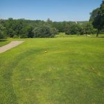 Panoramic view of a lush green golf course at Majestic Hills Golf Course. Smooth