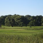 Panoramic view of a lush green golf course at Majestic Oaks Golf Club. Smooth