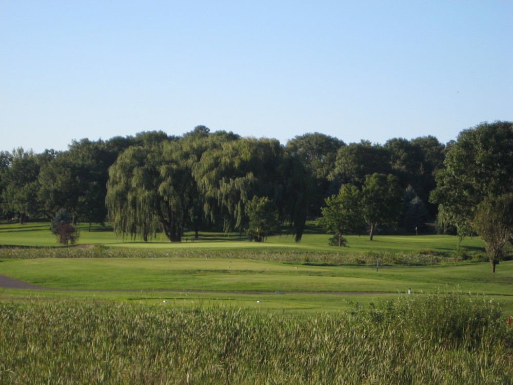 Panoramic view of a lush green golf course at Majestic Oaks Golf Club. Smooth