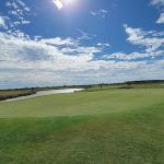 green grass with the flag in the hole.