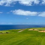 Panoramic view of a lush green golf course at Manele Golf Course. Smooth