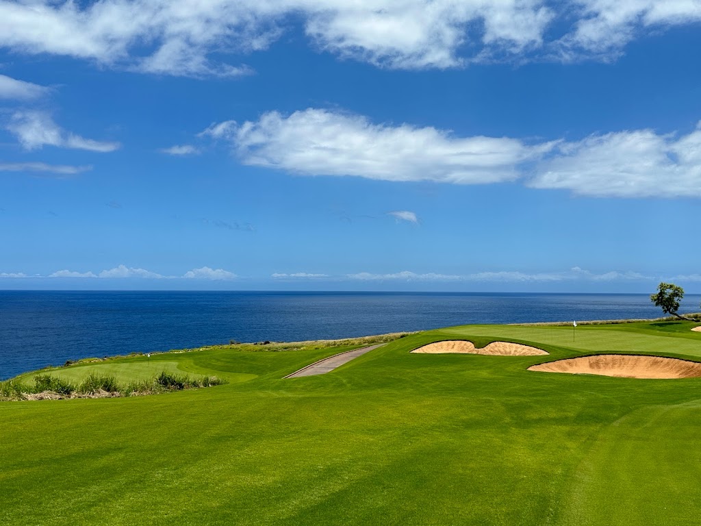 Panoramic view of a lush green golf course at Manele Golf Course. Smooth