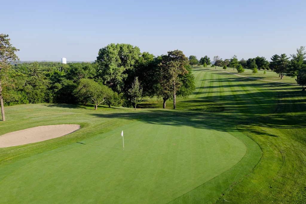 Panoramic view of a lush green golf course at Manhattan Country Club. Smooth