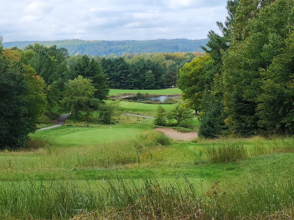 Panoramic view of a lush green golf course at Manitou Passage Golf Club. Smooth