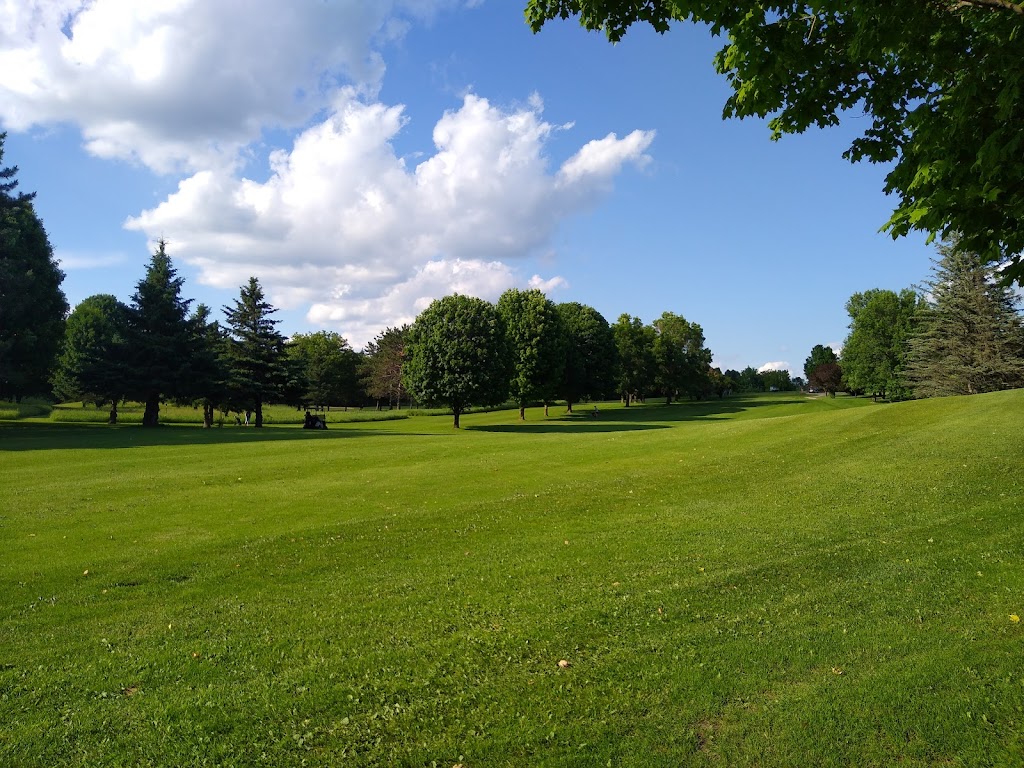 Panoramic view of a lush green golf course at Maple Hills Golf Course. Smooth