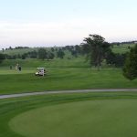 green grass with the flag in the hole.