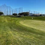 Panoramic view of a lush green golf course at Mariners Point Golf Center. Smooth