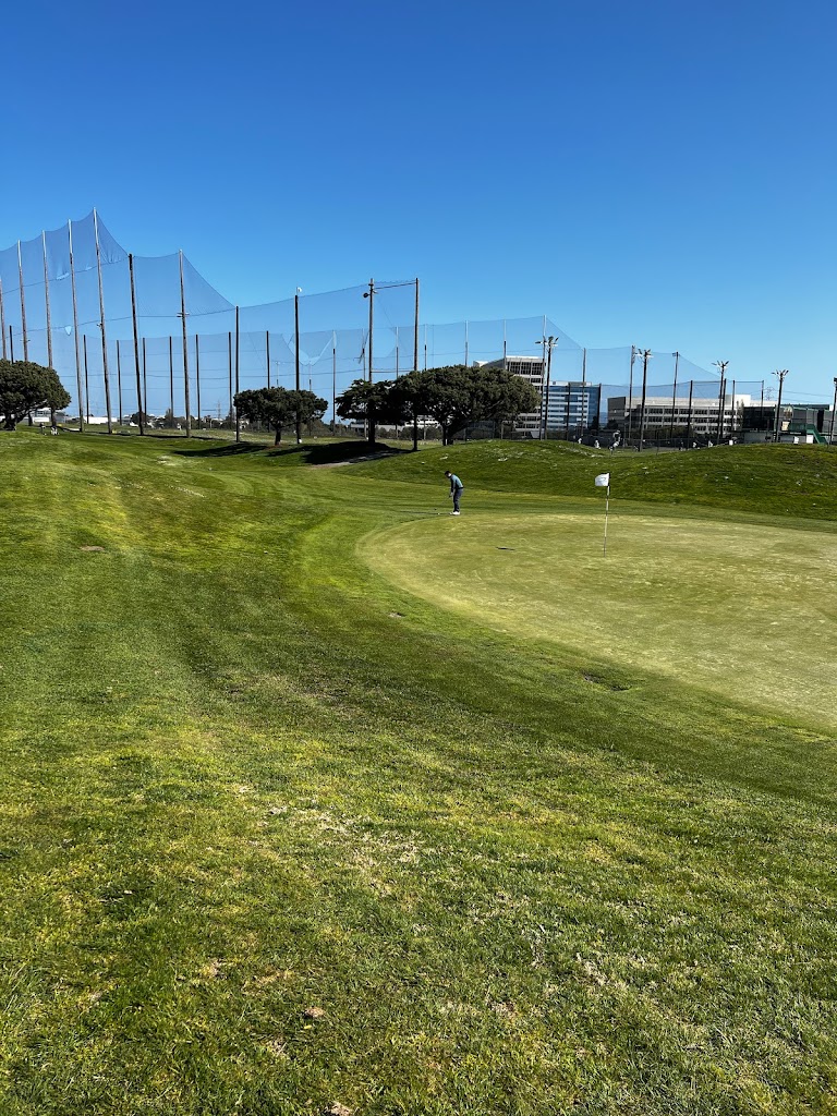 Panoramic view of a lush green golf course at Mariners Point Golf Center. Smooth