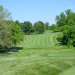 Panoramic view of a lush green golf course at Maryland Golf & Country Clubs. Smooth