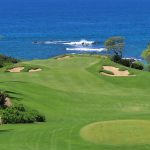 Panoramic view of a lush green golf course at Mauna Kea Golf Course. Smooth