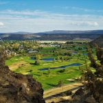 Panoramic view of a lush green golf course at Meadow Lakes Golf Course. Smooth