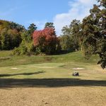 Panoramic view of a lush green golf course at Medal of Honor Golf Course. Smooth