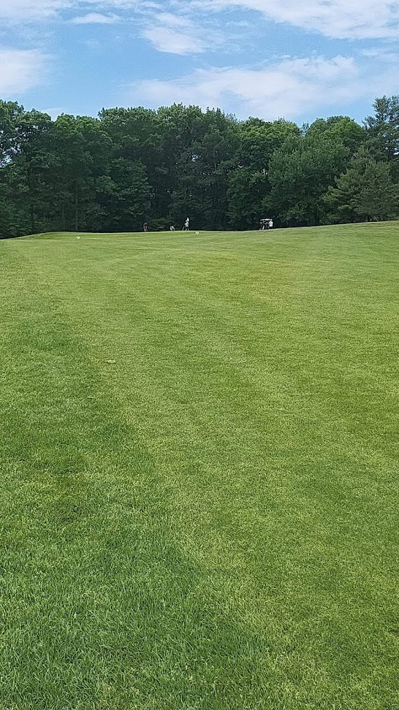 Panoramic view of a lush green golf course at Melody Hill Country Club. Smooth