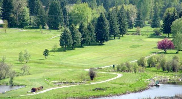 Panoramic view of a lush green golf course at Mirror Lake Golf Course. Smooth